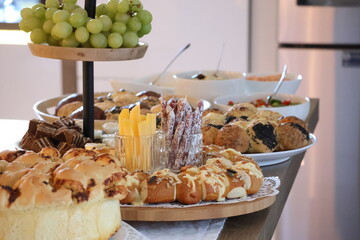 Snack buffet with cheese, dried sausages, bread with dip and grapes, rustic appetizer and finger food arrangement