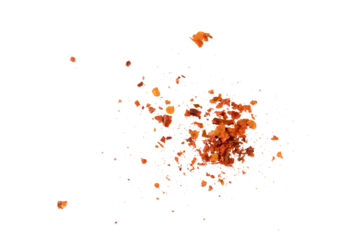 Flying crushed red pepper flakes scattered in air creating spicy seasoning texture and dynamic food explosion concept for cooking, hot flavor design, and culinary background