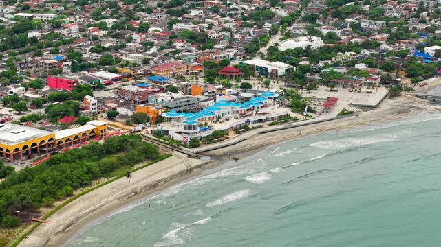 Drone footage showcasing the coastline, buildings, and caribbean sea in puerto colombia, atlantico