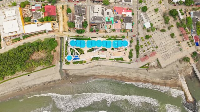 Aerial view of a seaside building and central square next to the ocean in puerto colombia
