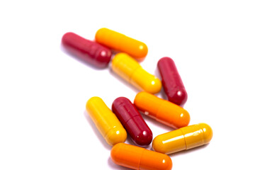 Pills. Tablets. Capsule. Heap of pills. Medical background. Close-up of pile of red white tablets - capsule. Pills and tablets.Blue background.