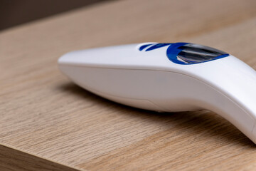 A modern handheld vacuum cleaner designed for quick and efficient cleaning on wooden surfaces, showcasing its sleek shape and ergonomic design for easy handling.