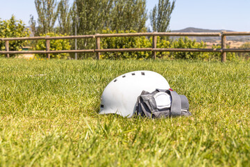 A white helmet and A gray wrist guard on the green grass background
