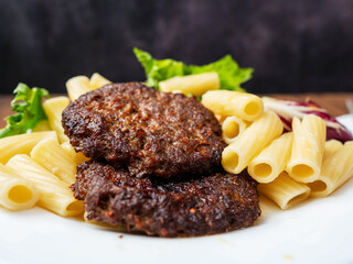 Meal with two tasty burgers, pasta and fresh salad and no sauce. Diet dinner for people with high blood sugar. Healthy food.