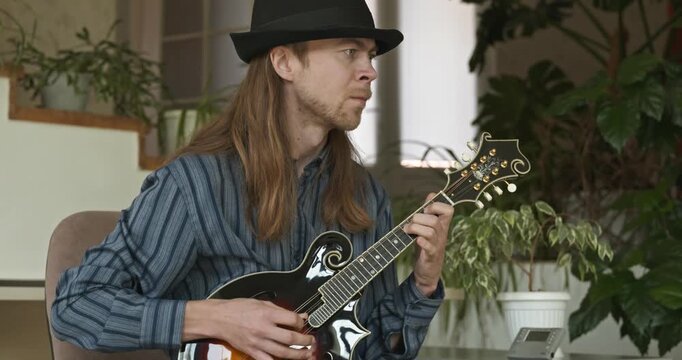 Male Musician Plays Mandolin. Caucasian Man Enjoys Playing Music 4K 10-bit
