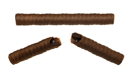 Wafer roll broken and whole flying, waffle stick with hazelnut and chocolate cream, isolated on white background