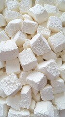 This close-up captures the smooth, creamy texture of cottage cheese with visible curds and a torn piece, all set against a crisp white backdrop