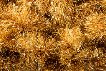 Golden tinsel Christmas tree bokeh background. Festive pattern. Xmas holiday spirit.