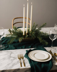 Elegant Winter Dining Room with Brass Cutlery and Greenery