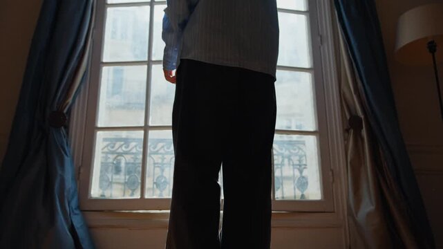 Person opening a french window in a parisian apartment