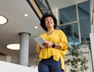 Portrait of a smart young businesswoman using a tablet computer in the office or classroom. Startup...