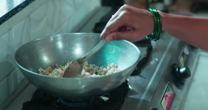 woman making sabudana dish for offering, and playful moment between couple with peanuts
