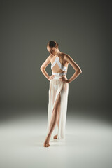 Fototapeta premium Graceful ballet performance by a young woman in a minimalist setting