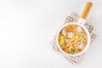 Homemade soup with chicken or turkey meatballs, pasta, vegetables and greens. White meat broth with vegetables and macaroni, healthy diet food, children's lunch