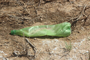 A plastic bottle lying on the ground, Plastic pollution, Plastic environmental impact