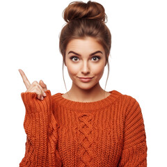 Young woman gesturing pointing up with orange sweater and bun hairstyle isolated on white background
