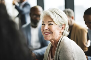 Senior Woman Smiling in Group Setting at Professional Networking Event.