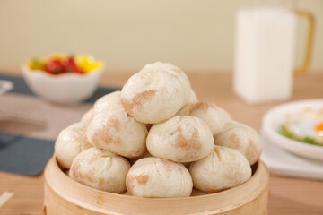 Delicious Small Steamed Buns in Bamboo Basket - Traditional Breakfast Combo with Fresh Fruit and Milk