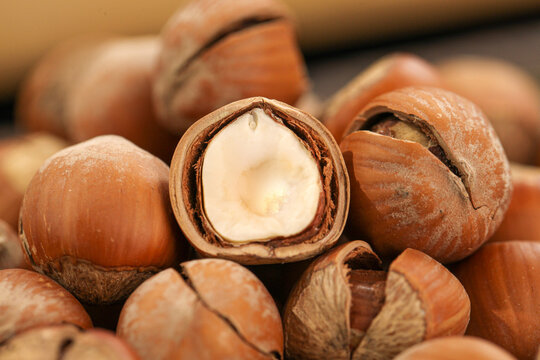 Hand-peeled hazelnuts with exposed kernels showing natural nut shells and meat for cooking and baking