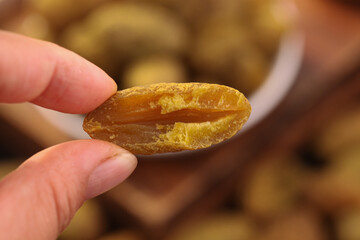 Hand Holding Cut Dried Fruit Showing Golden Interior Texture