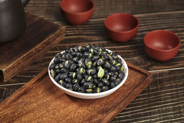 Fresh Black Beans with Green Sprouts in Bowl on Wooden Board with Clay Cups