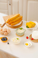 Fresh corn and breakfast ingredients on kitchen counter with natural lighting