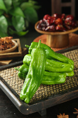 Fresh Green Tiger Peppers on Bamboo Tray with Asian Cooking Ingredients and Spices