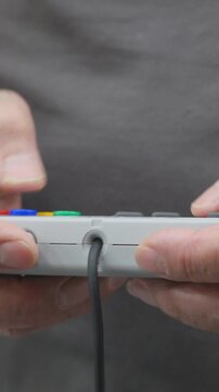 Close View Of Game Controller Being Held By Person. Vertical.