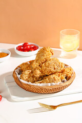 Crispy Fried Chicken Thighs in Basket with Condiments - Delicious Comfort Food Showcase