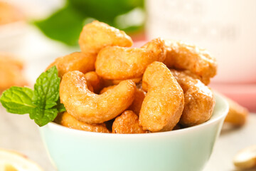 Crispy Roasted Cashew Nuts in Bowl with Fresh Mint Garnish - Healthy Snack Food Photography