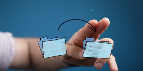 Hand moves digital files, showcasing data transfer, sharing, and online collaboration.