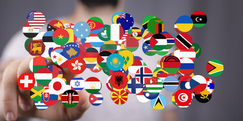 A person's hand interacting with a vibrant collection of flags representing diverse countries, symbolizing global connection and unity. Perfect