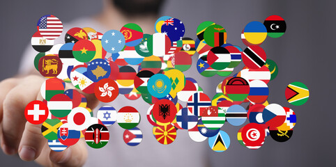 Obraz premium A hand displaying a vibrant collection of global country flags, symbolizing unity, diversity, and international collaboration. Perfect for theme