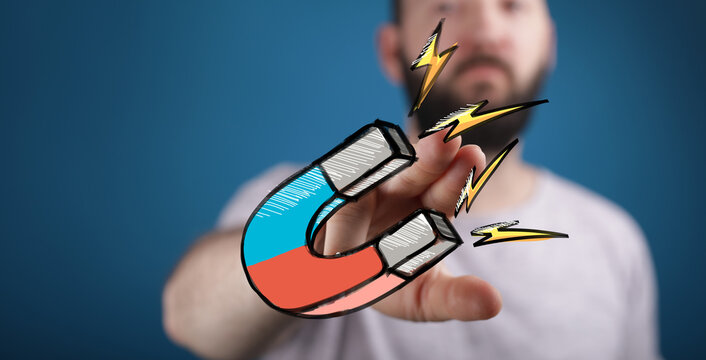 Powerful marketing image. Man attracts clients with a magnet. Ideal for business, sales, and marketing.