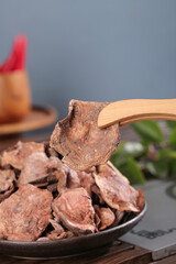 Yunnan Dried Porcini Mushrooms in Wooden Spoon - Premium Cooking Ingredients for Gourmet Asian Cuisine