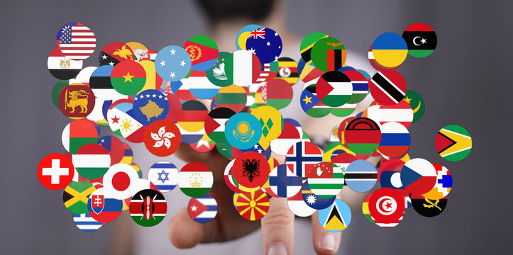 A hand interacts with a vibrant collection of country flags, symbolizing global connections, unity, and international cooperation. Perfect for i