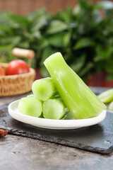 Fresh Green Celery Stalks on Plate with Organic Farm Vegetables in Kitchen Setting