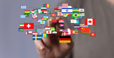 Symbolic image of a hand interacting with a network of connected country flags, representing global unity, communication, and interconnectedness