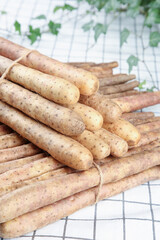 Fresh Huaishan Yam Roots from Henan Province - Traditional Chinese Medicine Tubers on White Checkered Background