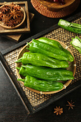 Fresh Green Chili Peppers in Bamboo Basket with Star Anise Spices for Asian Cooking