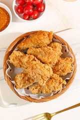 Crispy Fried Chicken Thighs in Basket with Cherry Tomatoes Food Photography