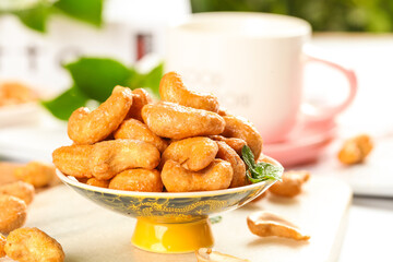 Crispy Roasted Cashew Nuts in Bowl with Tea Cup - Healthy Snack Food Photography