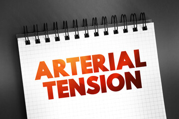 Arterial tension - the pressure of the blood within an artery, text concept on notepad
