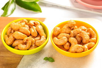 Fried Vietnamese Cashews in Colorful Bowls - Crispy Golden Nuts for New Year Celebration