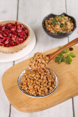 Japanese natto fermented soybeans with mixed beans and traditional Asian dishes on wooden background