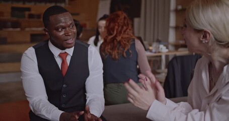 Multicultural business team discussing a project in a modern office space. The team is diverse and includes people of different ethnicities and ages. - Powered by Adobe