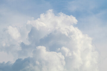 Fluffy white clouds floating under blue sky