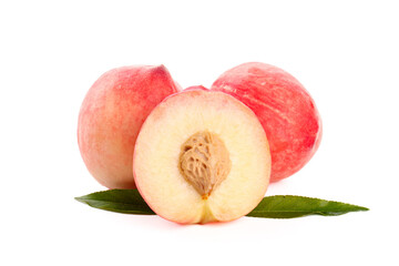 Fresh Ripe Peaches Cut in Half Showing Pit with Green Leaves on White Background