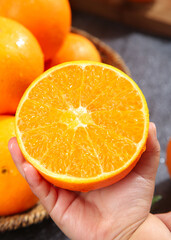 Fresh Gannan Navel Orange Half Showing Juicy Citrus Segments in Hand