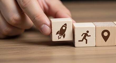 Fingers aligning wooden blocks symbolizing business growth and project launch stages